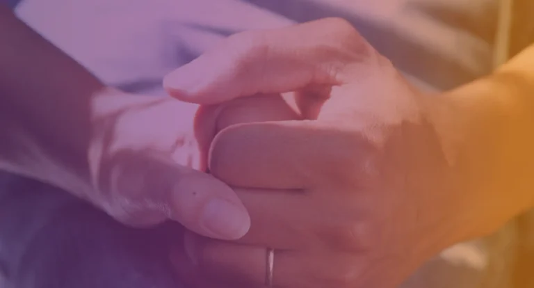 Jeanne Geiger Crisis Center logo background; two hands clasped