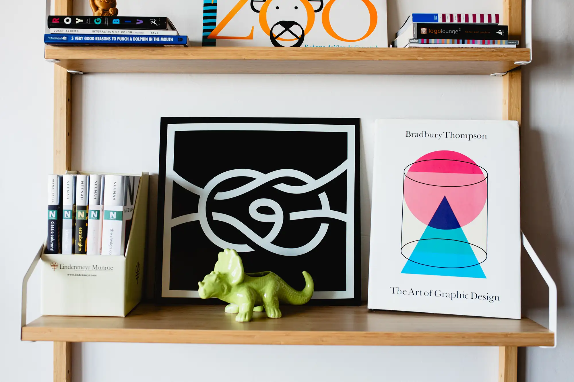Art on a bookcase at a graphic design studio